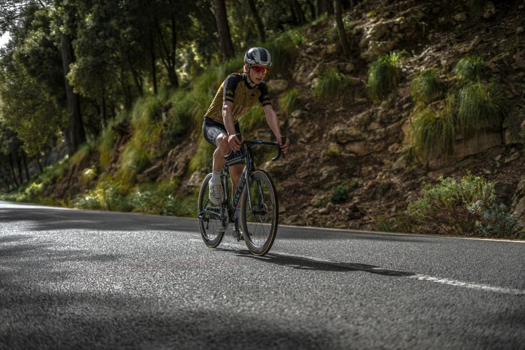 Road cyclist climbing a quiet mountain road on the Costa Blanca in winter sunshine